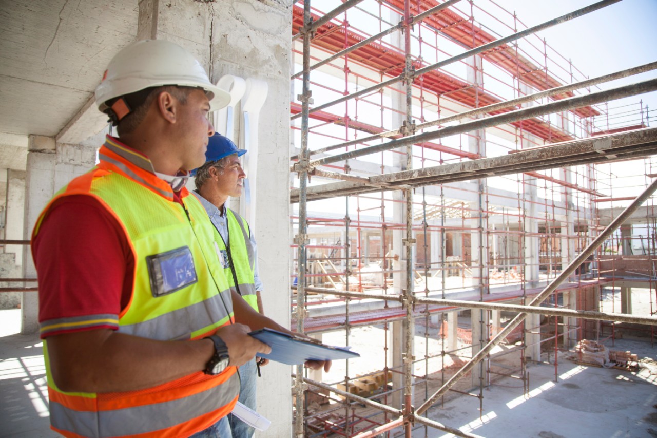Builders meeting on a large construction site of a new school