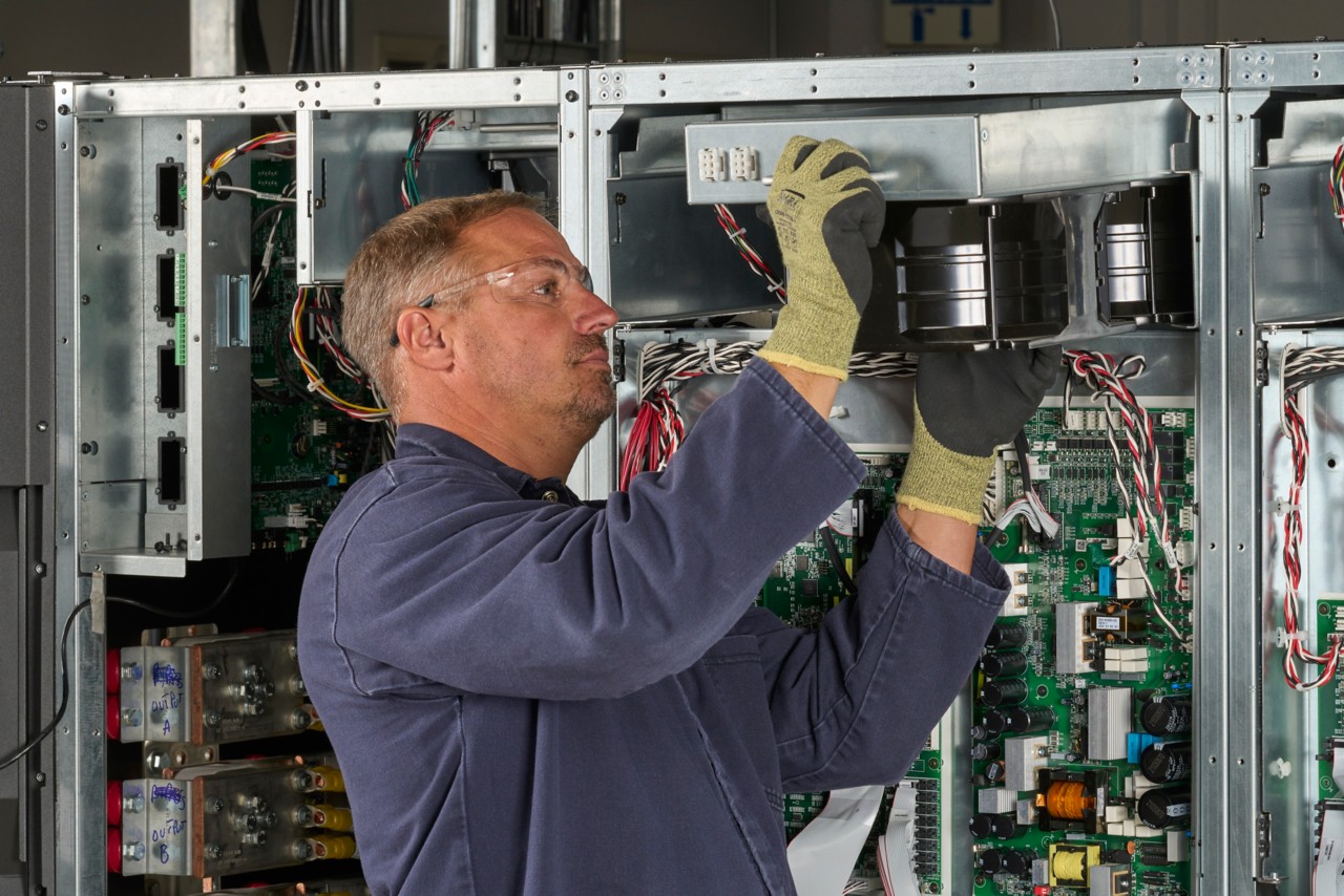 Man performing service on 9395XC by installing fan