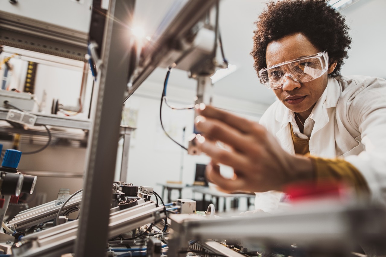 engineer-adjusting-industrial-machinery-getty-1127076087