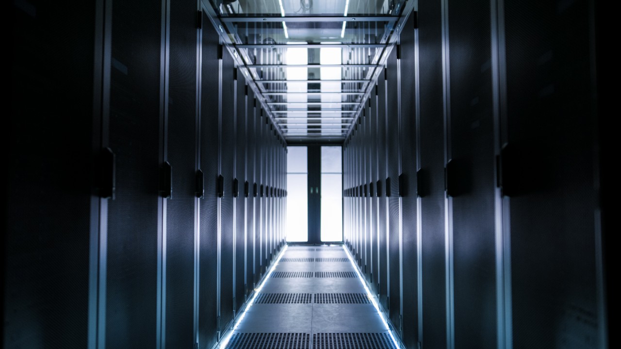 Shot of Corridor in Large Working Data Center Full of Rack Servers and Supercomputers.