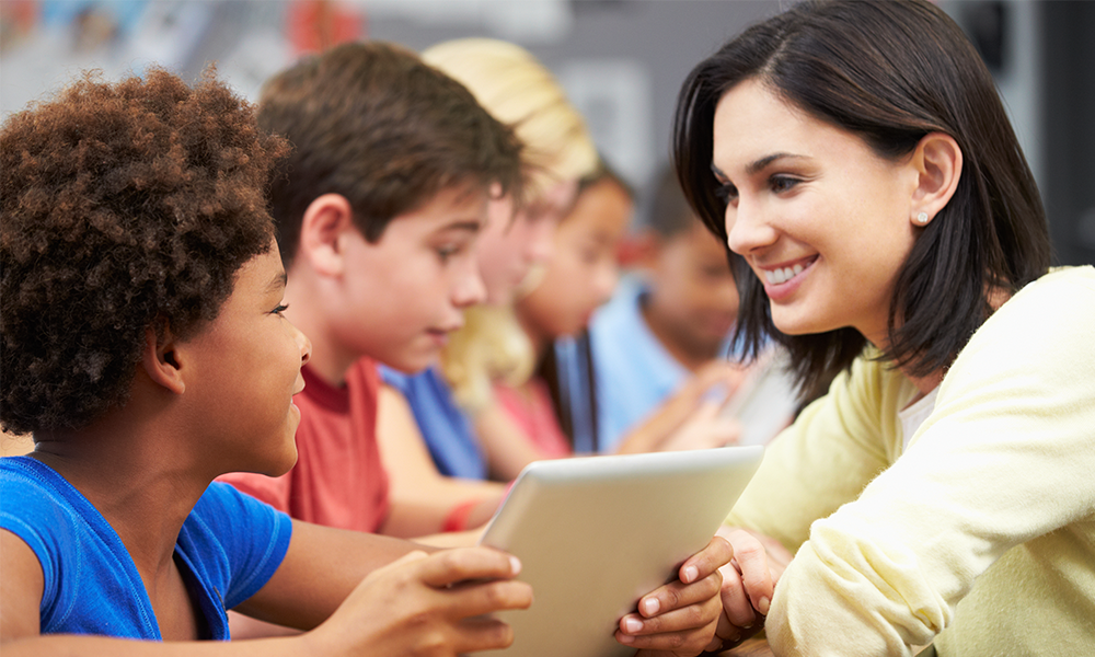 k-12 teacher in classroom with students
