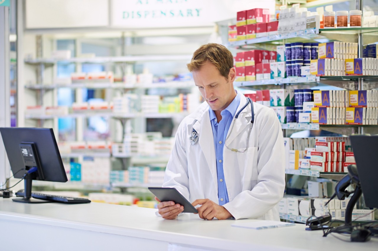 A pharmacist working on a digital tablet. The commercial product(s) or designs displayed in this image represent simulations of a real product, and are changed or altered enough so that they are free of any copyright infringements. Our team of retouching and design specialists custom designed these elements for each photo shoot http://195.154.178.81/DATA/i_collage/pi/shoots/784992.jpg