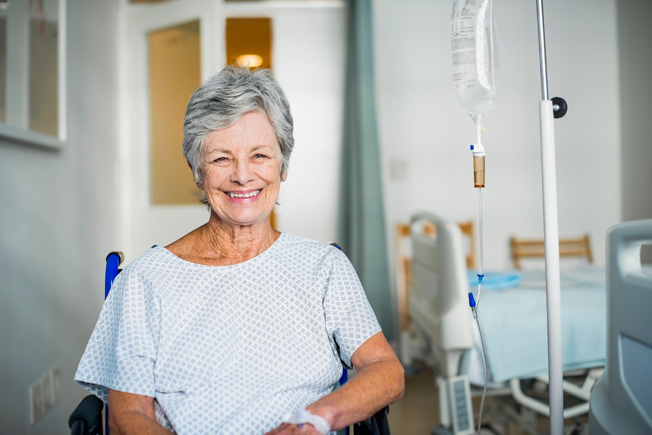 Senior woman sitting in a wheelchair in recovery room at hospital